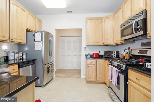 1009 Samantha Ln Unit 302, Odenton, MD 21113 - kitchen with stainless steel appliances, light brown cabinetry, and dark countertops