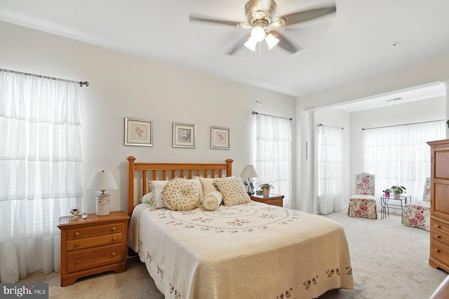 1009 Samantha Ln Unit 302, Odenton, MD 21113 - bedroom featuring light carpet, multiple windows, ornate columns, and ceiling fan