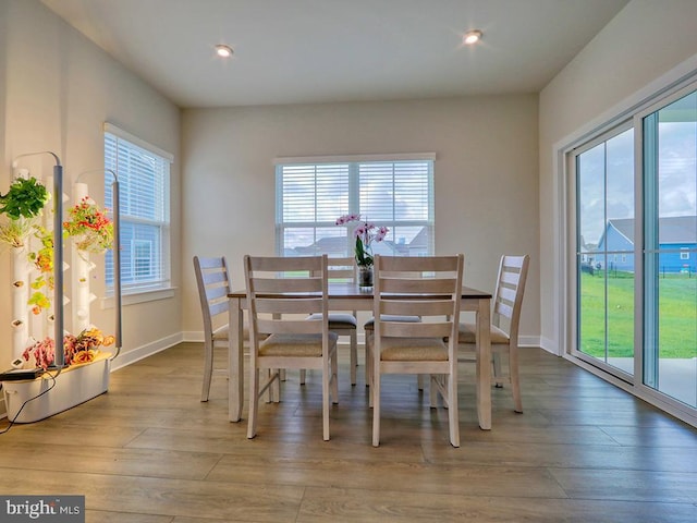 dining area with wood-type flooring, recessed lighting, and baseboards