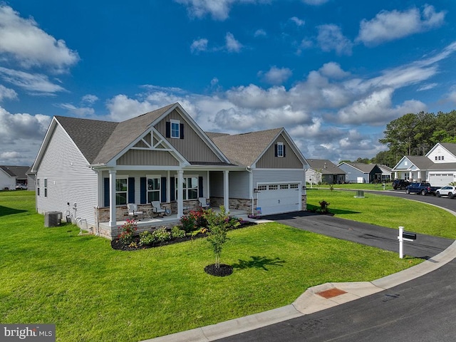 craftsman-style home featuring a porch, a front lawn, driveway, and roof with shingles