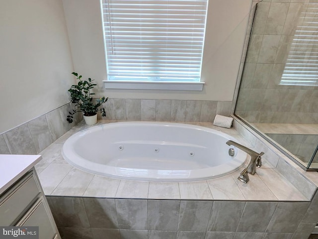 full bath with vanity and a tub with jets