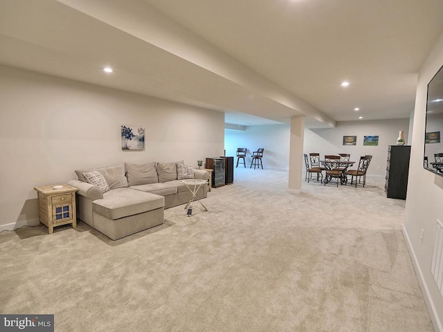 living area featuring light colored carpet, recessed lighting, and baseboards