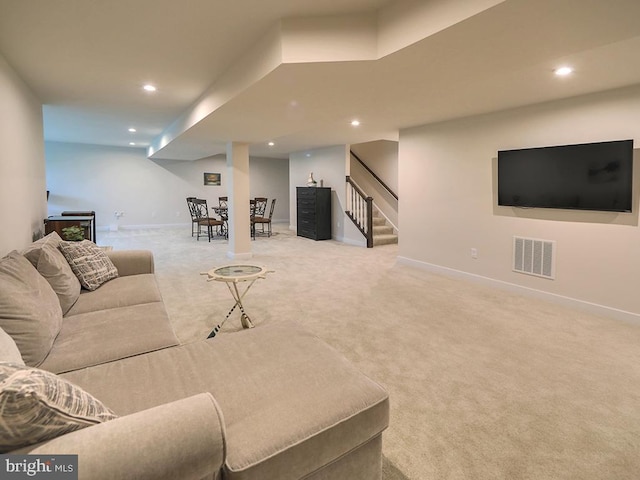 carpeted living room featuring stairway, baseboards, and recessed lighting