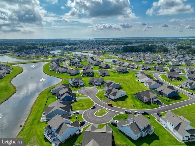 aerial perspective of suburban area with a nearby body of water