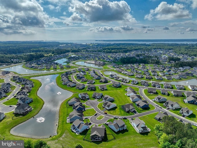 aerial view of residential area featuring a large body of water