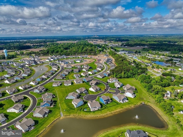 aerial view of property and surrounding area featuring a large body of water and nearby suburban area