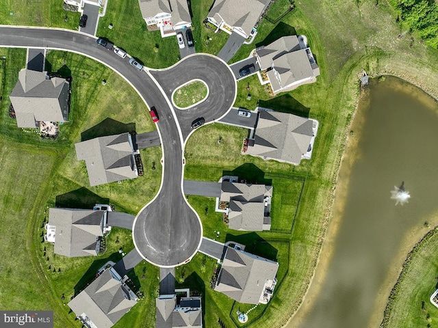 aerial view of property's location featuring nearby suburban area and a large body of water