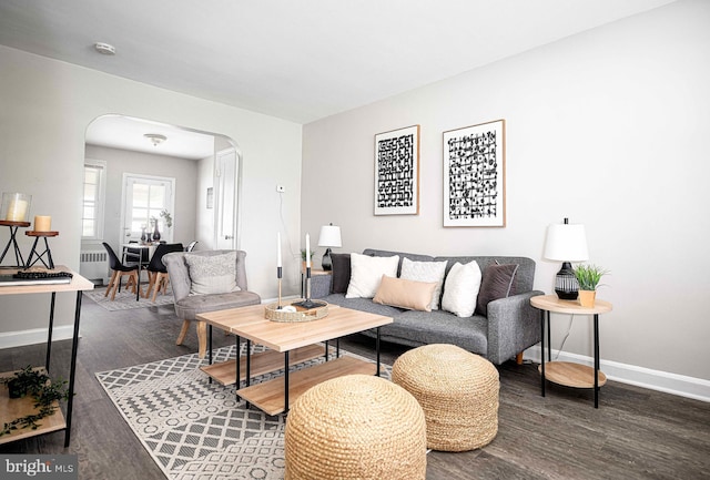 3565 Benzinger Rd, Baltimore, MD 21229 - living room featuring arched walkways, wood finished floors, and baseboards