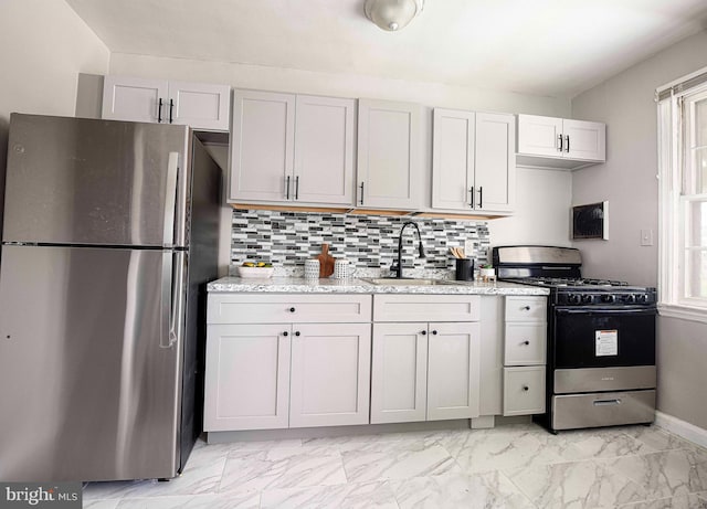 3565 Benzinger Rd, Baltimore, MD 21229 - kitchen featuring appliances with stainless steel finishes, a sink, light marble finish floors, backsplash, and baseboards