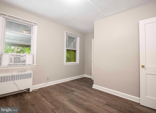 3565 Benzinger Rd, Baltimore, MD 21229 - empty room with radiator heating unit, dark wood-type flooring, cooling unit, plenty of natural light, and a textured ceiling
