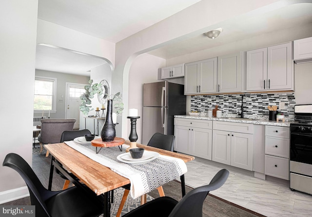 3565 Benzinger Rd, Baltimore, MD 21229 - dining space with arched walkways and light marble finish flooring
