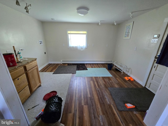 26689 Mariners Rd, Crisfield, MD 21817 - interior space with track lighting, a baseboard radiator, dark wood-style floors, and baseboards