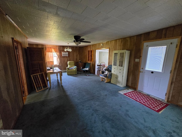 26689 Mariners Rd, Crisfield, MD 21817 - carpeted living area featuring wood walls, ceiling fan, and an AC wall unit