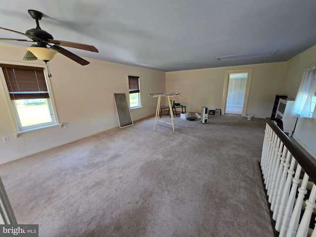 26689 Mariners Rd, Crisfield, MD 21817 - unfurnished living room featuring attic access, plenty of natural light, ceiling fan, and carpet flooring