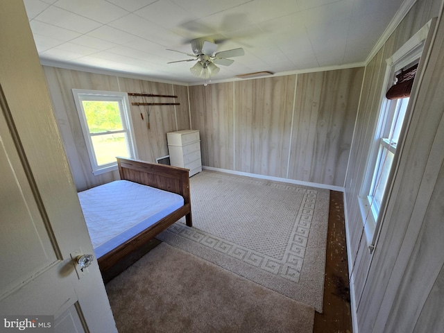 26689 Mariners Rd, Crisfield, MD 21817 - bedroom featuring carpet flooring, a ceiling fan, crown molding, wooden walls, and baseboards