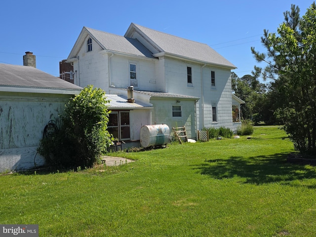 26689 Mariners Rd, Crisfield, MD 21817 - rear view of house with oil tank, a yard, and roof with shingles