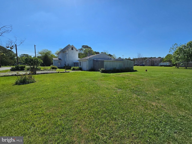 26689 Mariners Rd, Crisfield, MD 21817 - view of green lawn featuring an attached garage