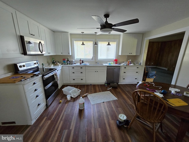 26689 Mariners Rd, Crisfield, MD 21817 - kitchen featuring stainless steel appliances, dark wood-style floors, light countertops, and white cabinets