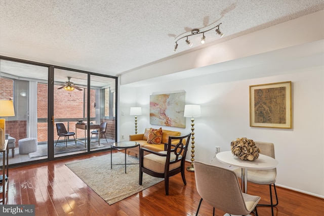 1001 N Vermont St Unit 812, Arlington, VA 22201 - living area featuring hardwood / wood-style flooring, a wall of windows, a textured ceiling, ceiling fan, and baseboards