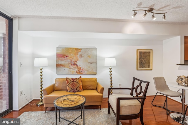 1001 N Vermont St Unit 812, Arlington, VA 22201 - living area with wood finished floors, baseboards, and a textured ceiling