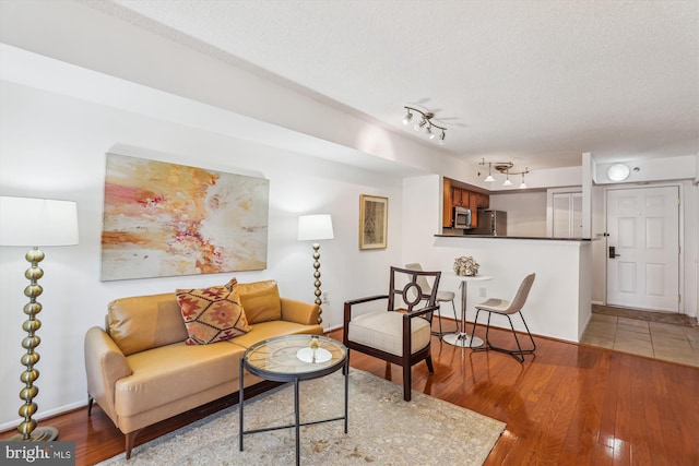 1001 N Vermont St Unit 812, Arlington, VA 22201 - living area with wood finished floors, baseboards, a textured ceiling, and rail lighting