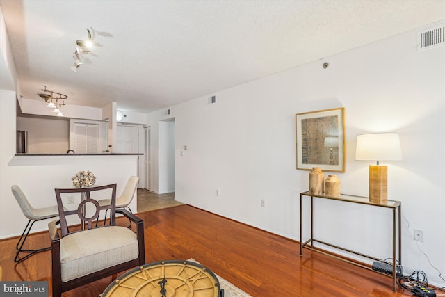 1001 N Vermont St Unit 812, Arlington, VA 22201 - dining room featuring wood finished floors and a textured ceiling