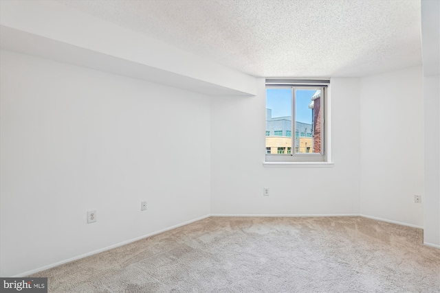 1001 N Vermont St Unit 812, Arlington, VA 22201 - empty room featuring a textured ceiling, carpet flooring, and baseboards