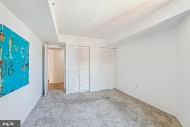 1001 N Vermont St Unit 812, Arlington, VA 22201 - unfurnished bedroom featuring carpet floors, a closet, and a textured ceiling