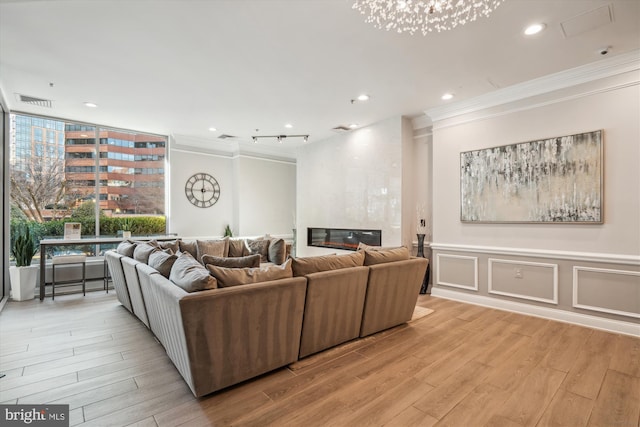 1001 N Vermont St Unit 812, Arlington, VA 22201 - living area with ornamental molding, light wood finished floors, recessed lighting, and a fireplace