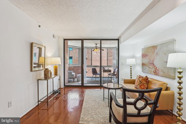1001 N Vermont St Unit 812, Arlington, VA 22201 - living room with a textured ceiling, wood-type flooring, floor to ceiling windows, a ceiling fan, and baseboards
