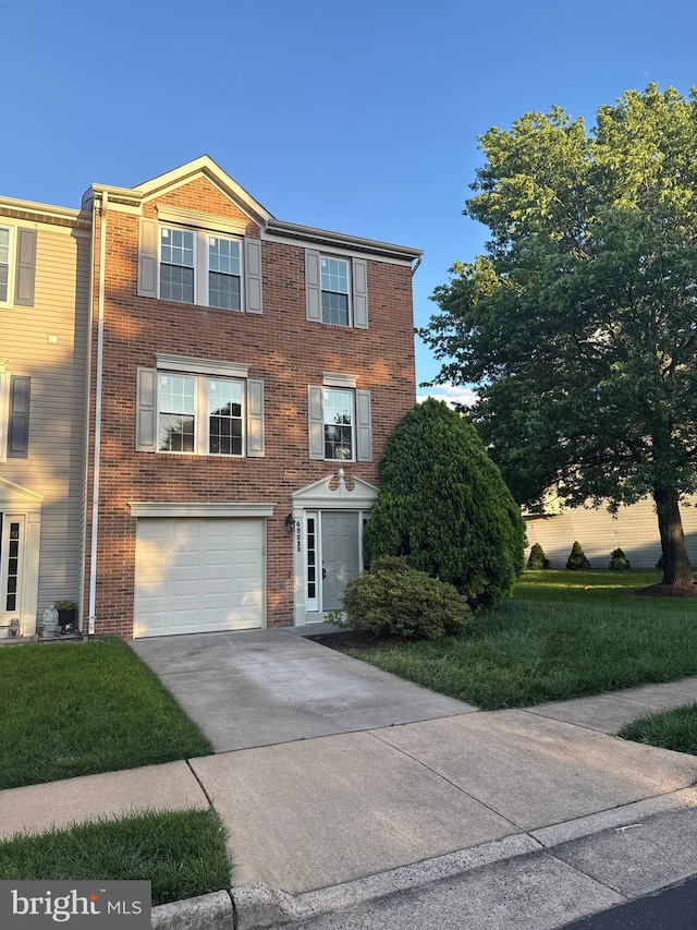 43212 Chokeberry Sq, Ashburn, VA 20147 - view of front of home featuring concrete driveway, a garage, and brick siding