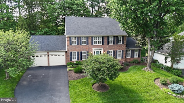 8346 Argent Cir, Fairfax Station, VA 22039 - colonial house featuring a garage, driveway, brick siding, and a front lawn