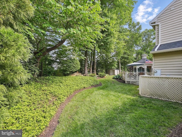 8346 Argent Cir, Fairfax Station, VA 22039 - view of grassy yard with a gazebo, a deck, and view of scattered trees