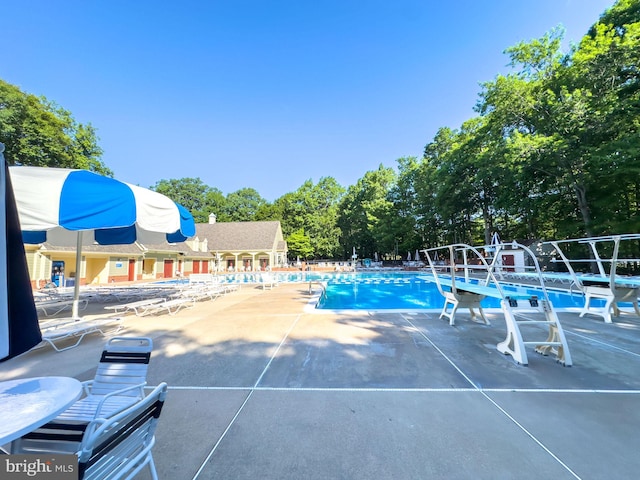 8346 Argent Cir, Fairfax Station, VA 22039 - community pool with a patio and view of wooded area