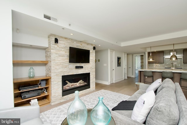 2818 Connecticut Ave NW Unit 503, Washington, DC 20008 - living area with a stone fireplace, light wood-type flooring, baseboards, and recessed lighting