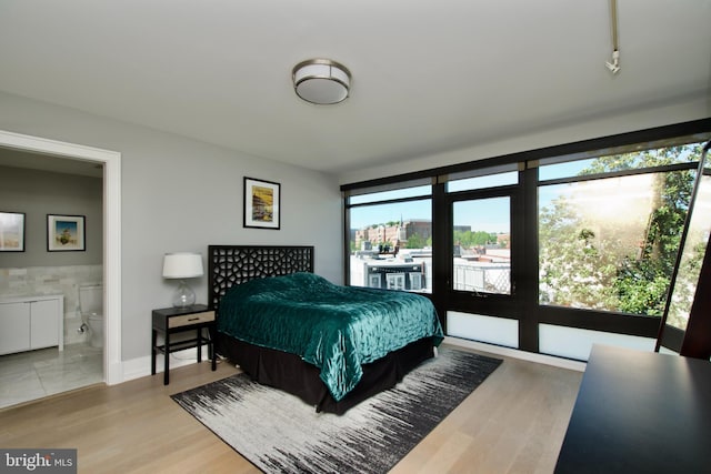 2818 Connecticut Ave NW Unit 503, Washington, DC 20008 - bedroom with access to outside, ensuite bath, and wood finished floors