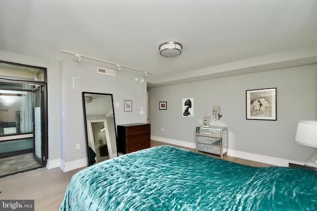 2818 Connecticut Ave NW Unit 503, Washington, DC 20008 - bedroom featuring wood finished floors, track lighting, and baseboards