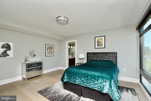 2818 Connecticut Ave NW Unit 503, Washington, DC 20008 - bedroom with wood finished floors, multiple windows, ensuite bath, and baseboards