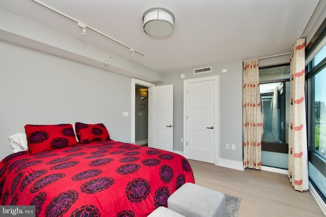 2818 Connecticut Ave NW Unit 503, Washington, DC 20008 - bedroom with wood finished floors, track lighting, and baseboards