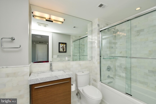 2818 Connecticut Ave NW Unit 503, Washington, DC 20008 - full bath with tile walls, vanity, toilet, and shower / bath combination with glass door