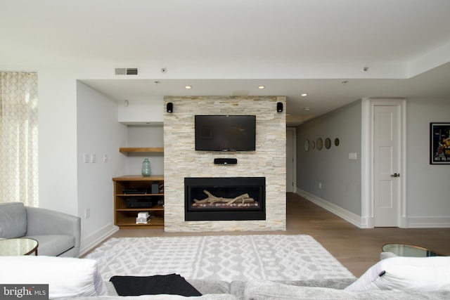 2818 Connecticut Ave NW Unit 503, Washington, DC 20008 - living room with wood finished floors, baseboards, a tiled fireplace, and recessed lighting
