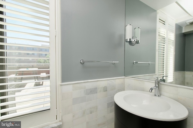 2818 Connecticut Ave NW Unit 503, Washington, DC 20008 - bathroom with tile walls, plenty of natural light, a wainscoted wall, and vanity