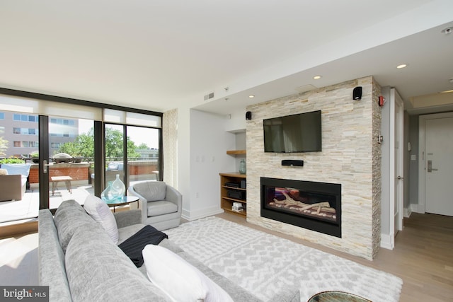 2818 Connecticut Ave NW Unit 503, Washington, DC 20008 - living room with baseboards, wood finished floors, a large fireplace, and expansive windows