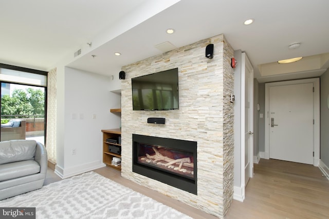 2818 Connecticut Ave NW Unit 503, Washington, DC 20008 - living area featuring baseboards, wood finished floors, a stone fireplace, and recessed lighting