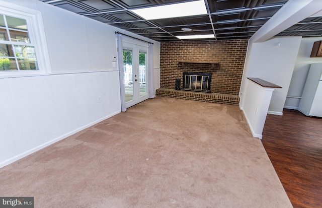 6300 Mallard Ln, Lothian, MD 20711 - unfurnished living room featuring baseboards, a fireplace, french doors, and wood finished floors