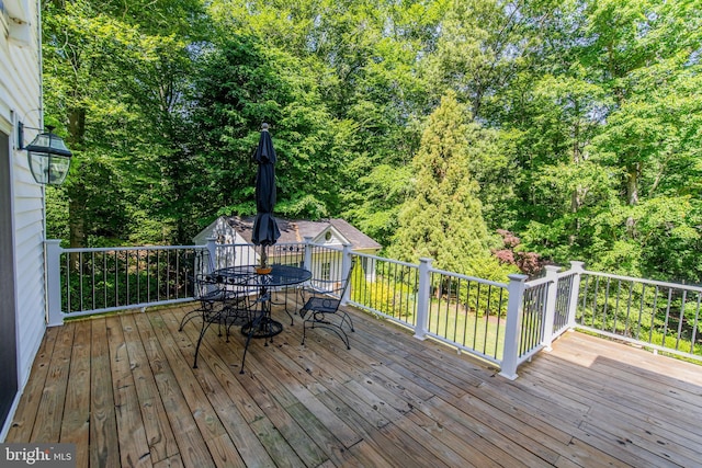 6300 Mallard Ln, Lothian, MD 20711 - wooden deck with outdoor dining space and a forest view