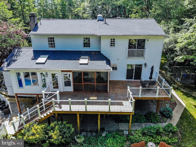 6300 Mallard Ln, Lothian, MD 20711 - back of house with a deck, a sunroom, a chimney, and a shingled roof