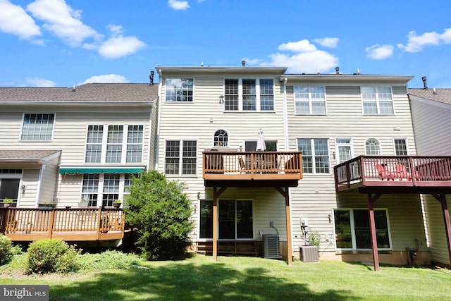 back of house with a yard, cooling unit, and a wooden deck