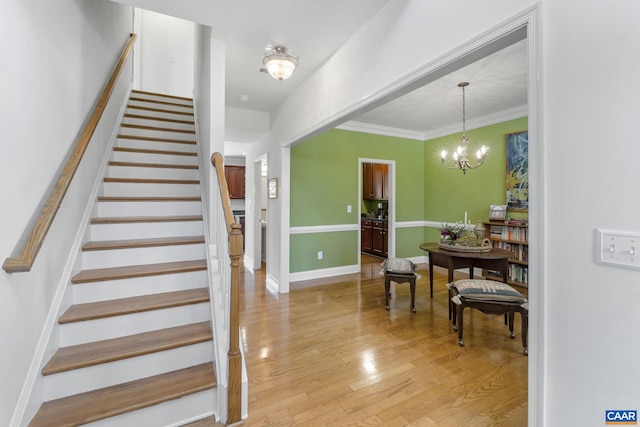3080 Morewood Ln, Charlottesville, VA 22901 - stairway featuring wood finished floors, a chandelier, ornamental molding, and baseboards