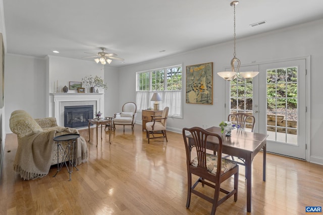 3080 Morewood Ln, Charlottesville, VA 22901 - dining area featuring ornamental molding, a glass covered fireplace, light wood-style flooring, ceiling fan, and baseboards